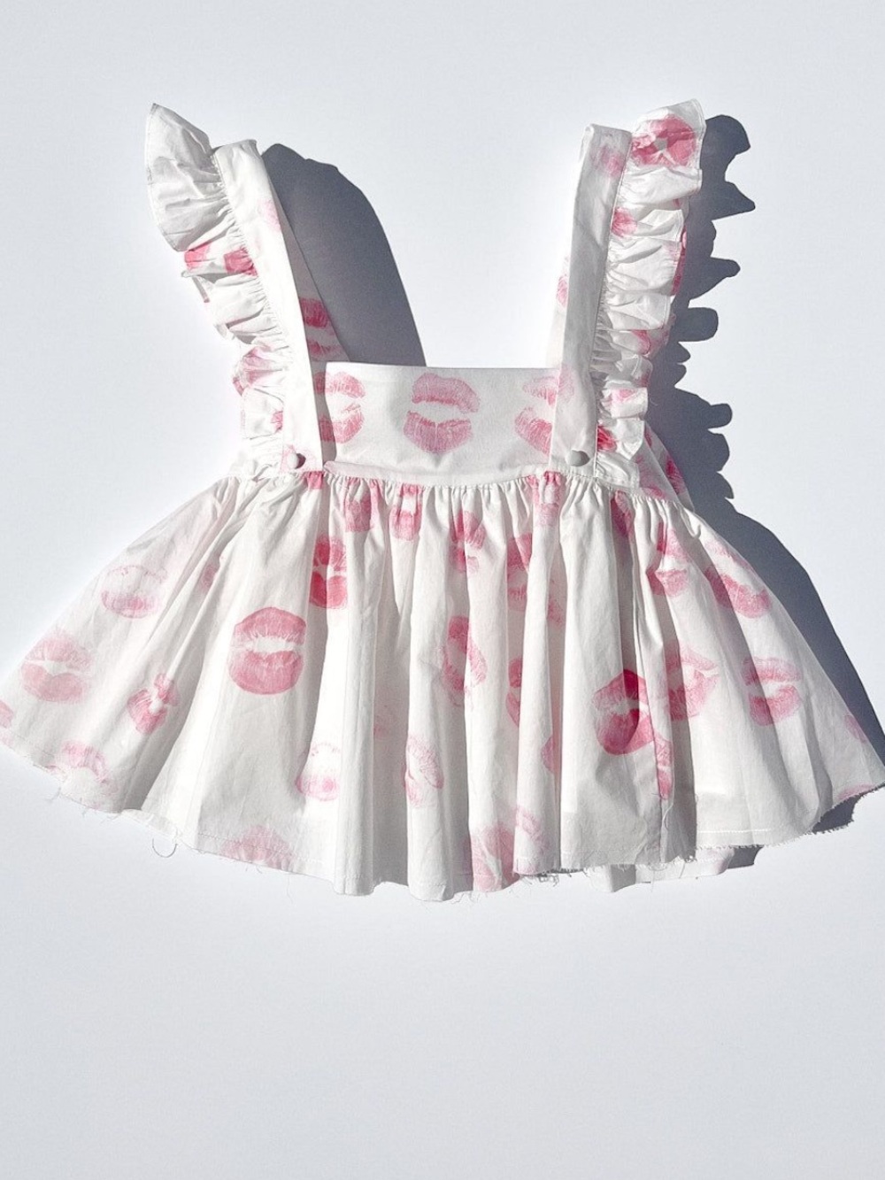 Selkie Apron Top White Ruffle Top with Pink Kiss Print